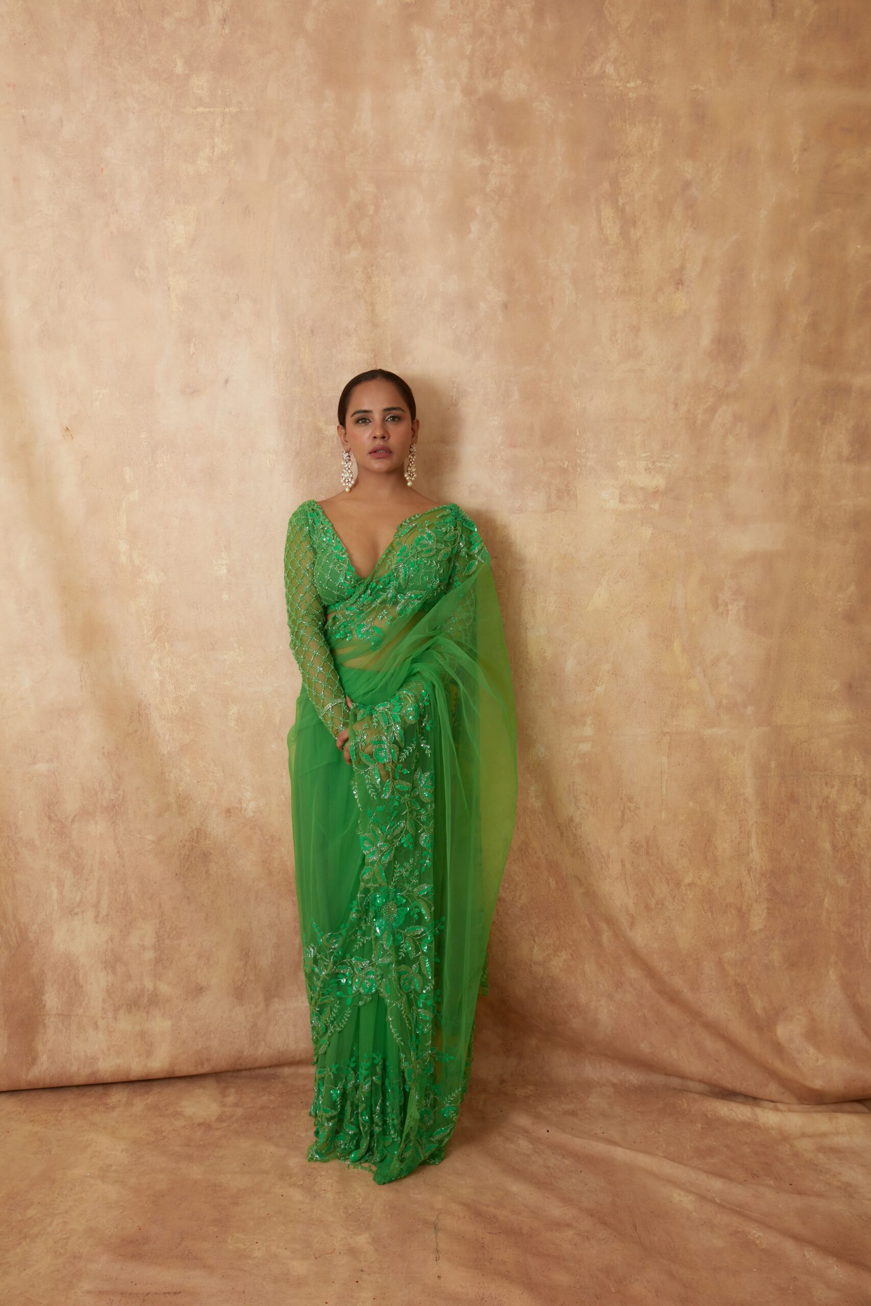 Vibrant Green Saree with intricate embroidary work along the delicate net fabric